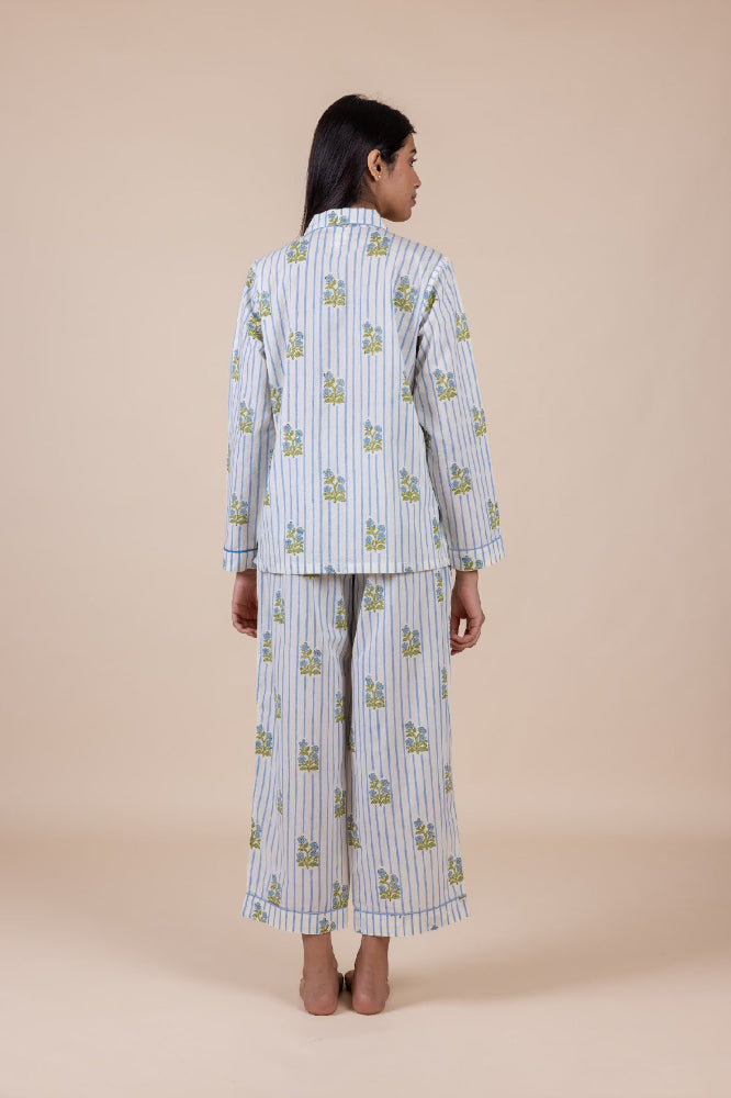 Woman wearing a matching pajama set with a beige background