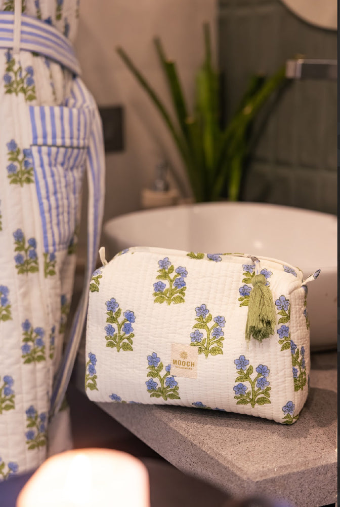 Blue and green floral quilted wash bag in lifestyle image