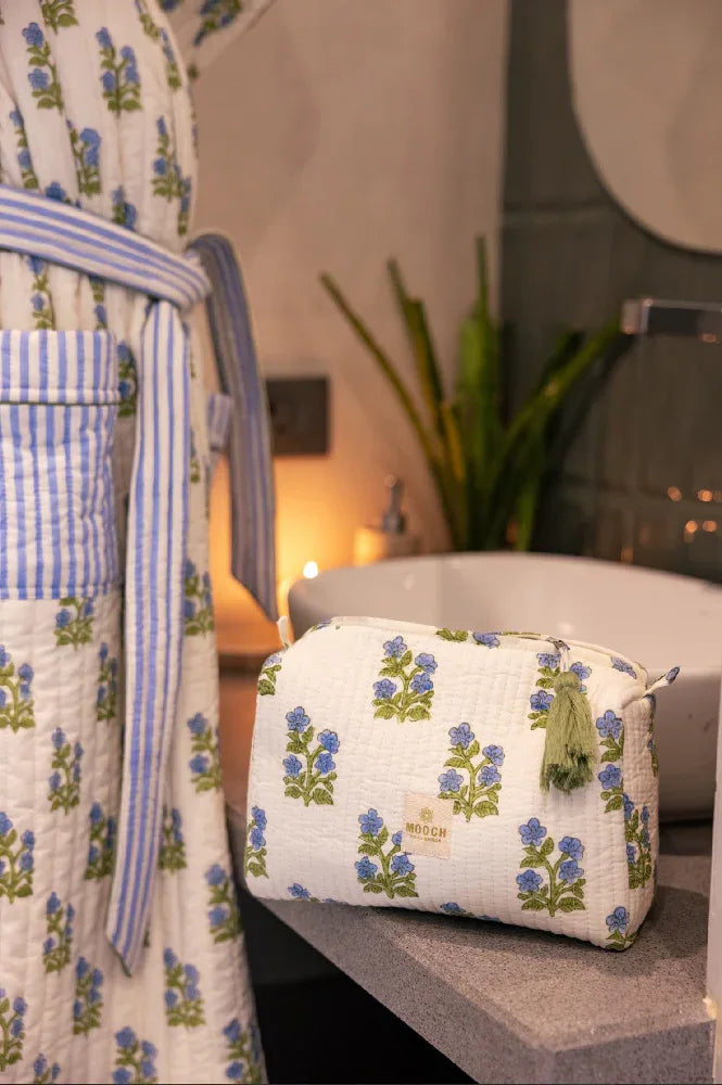 Blue and green floral quilted wash bag in lifestyle image