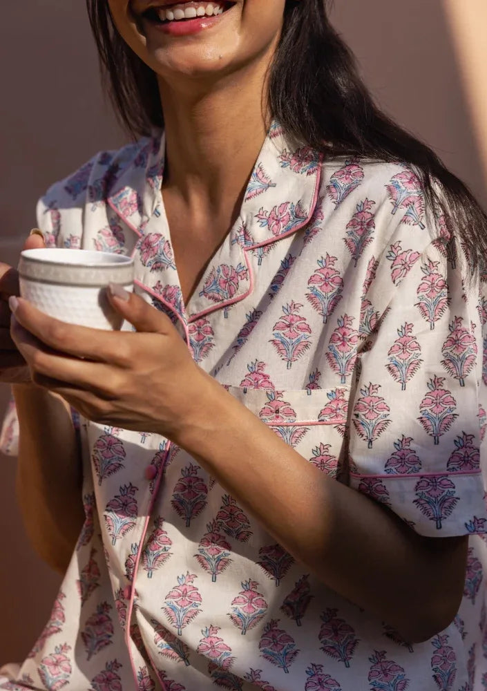 Model smiling and wearing Booti Blush Bloom Pyjamas