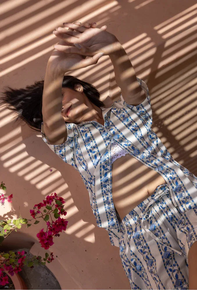 Model lying down wearing Cobalt Ribbon Cotton Pyjamas