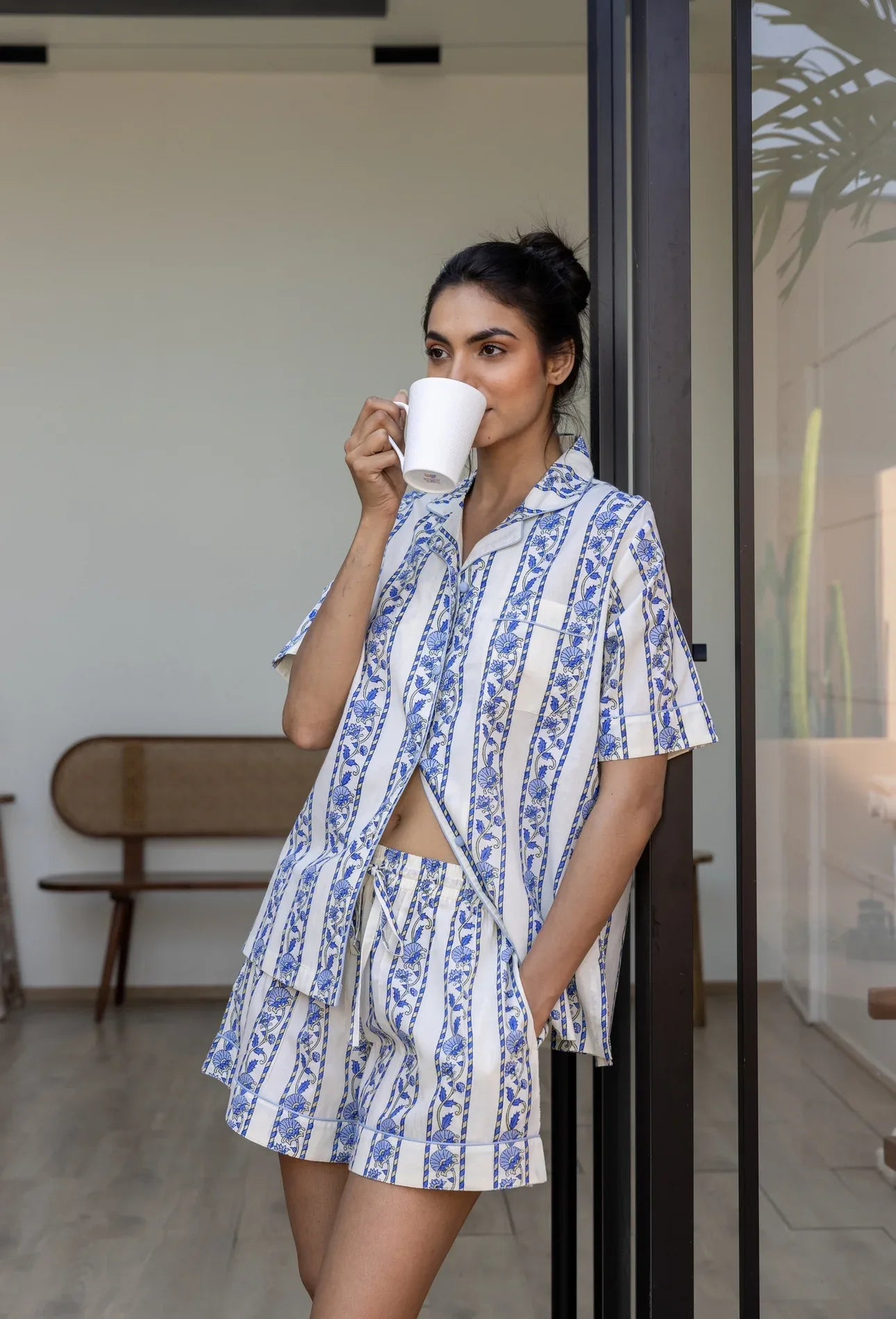 Model drinking from a mug wearing Cobalt Ribbon Cotton Pyjamas