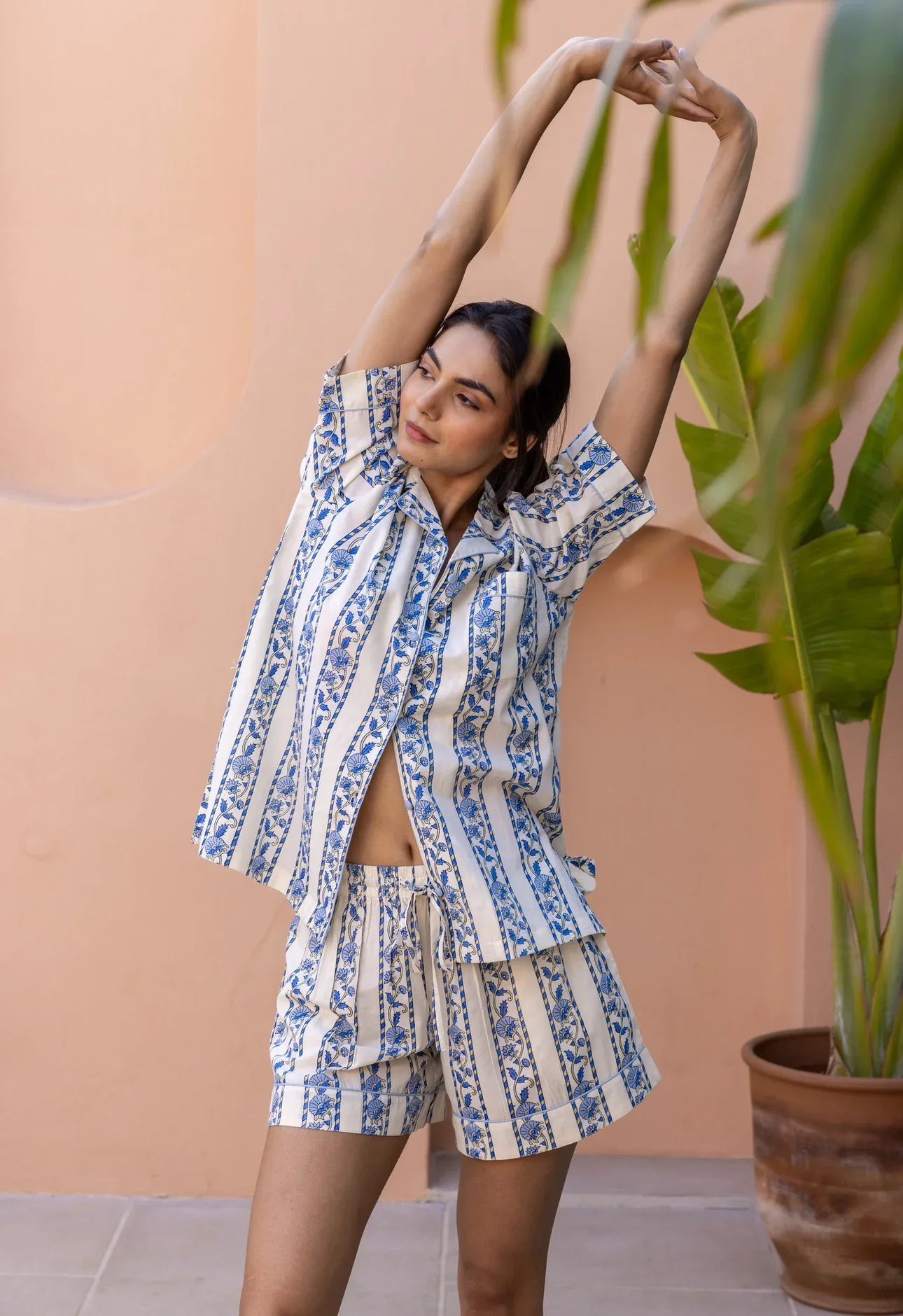 Model stretching and wearing Cobalt Ribbon Cotton Pyjamas