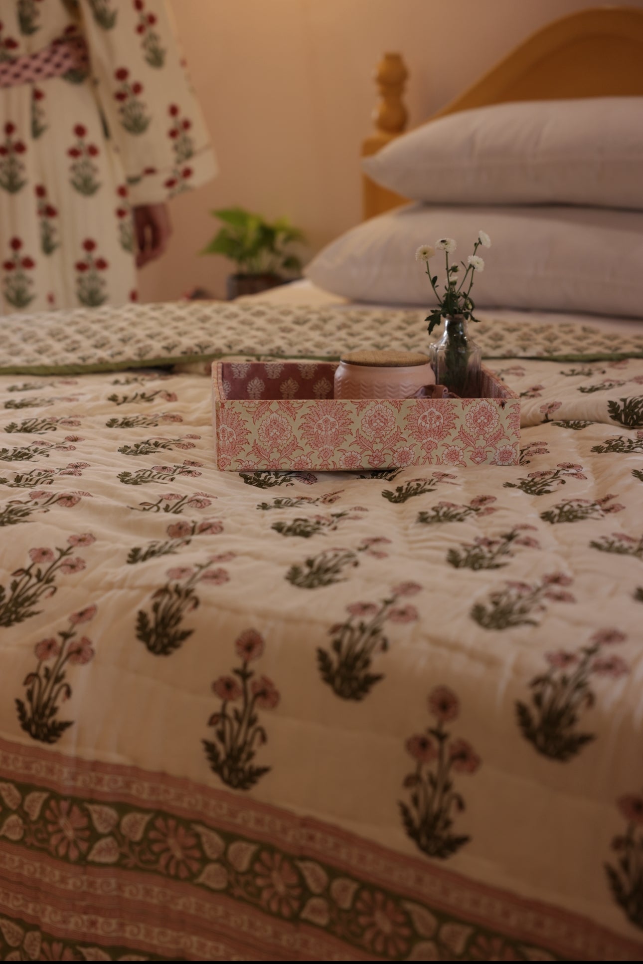 Paxford willow quilt with a tray and flowers and model in dressing gown