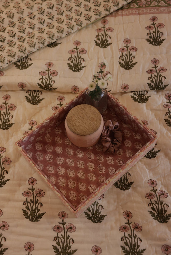 Paxford Willow quilted bedspread with a decorative tray with a ceramic bowl and flowers