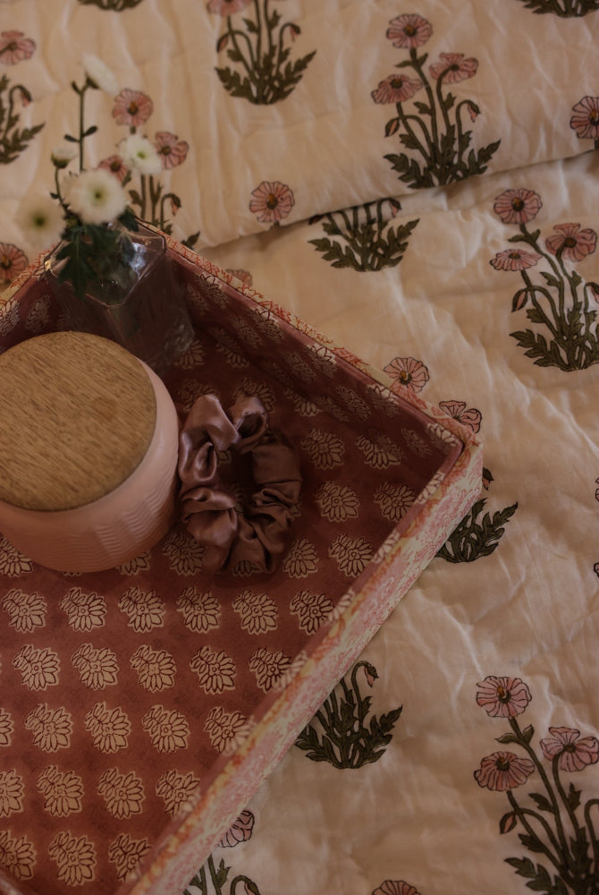 Fabric decorative tray with a candle on a condicote poppy quilt