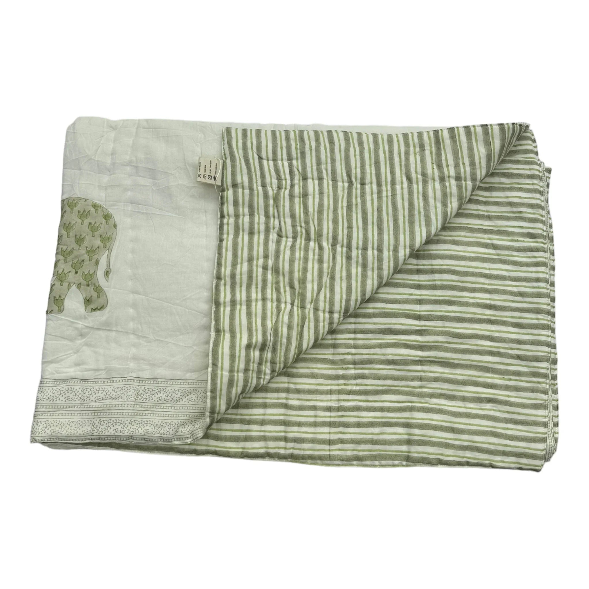 Enzo quilt on white background folded back to see reverse side