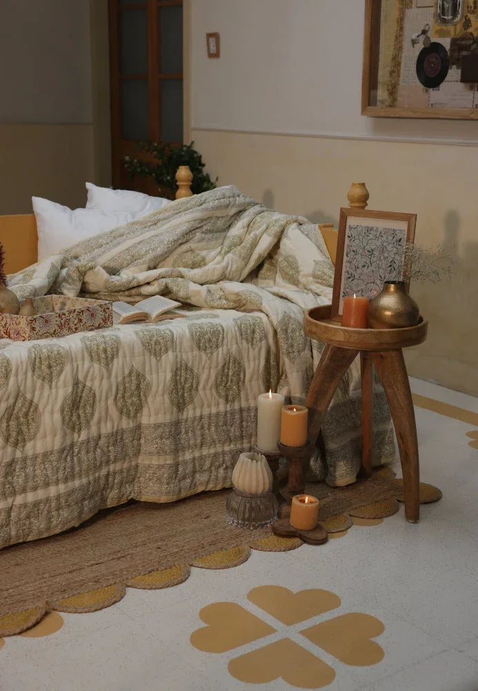 Cosy bedroom with a bed, wooden side table, and kiftsgate stone quilt