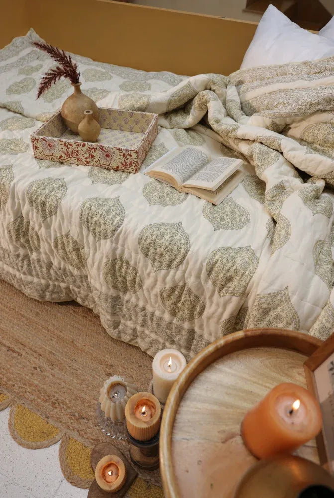 Cozy bedroom scene with a bed, candles, and kiftsgate stone eiderdown.