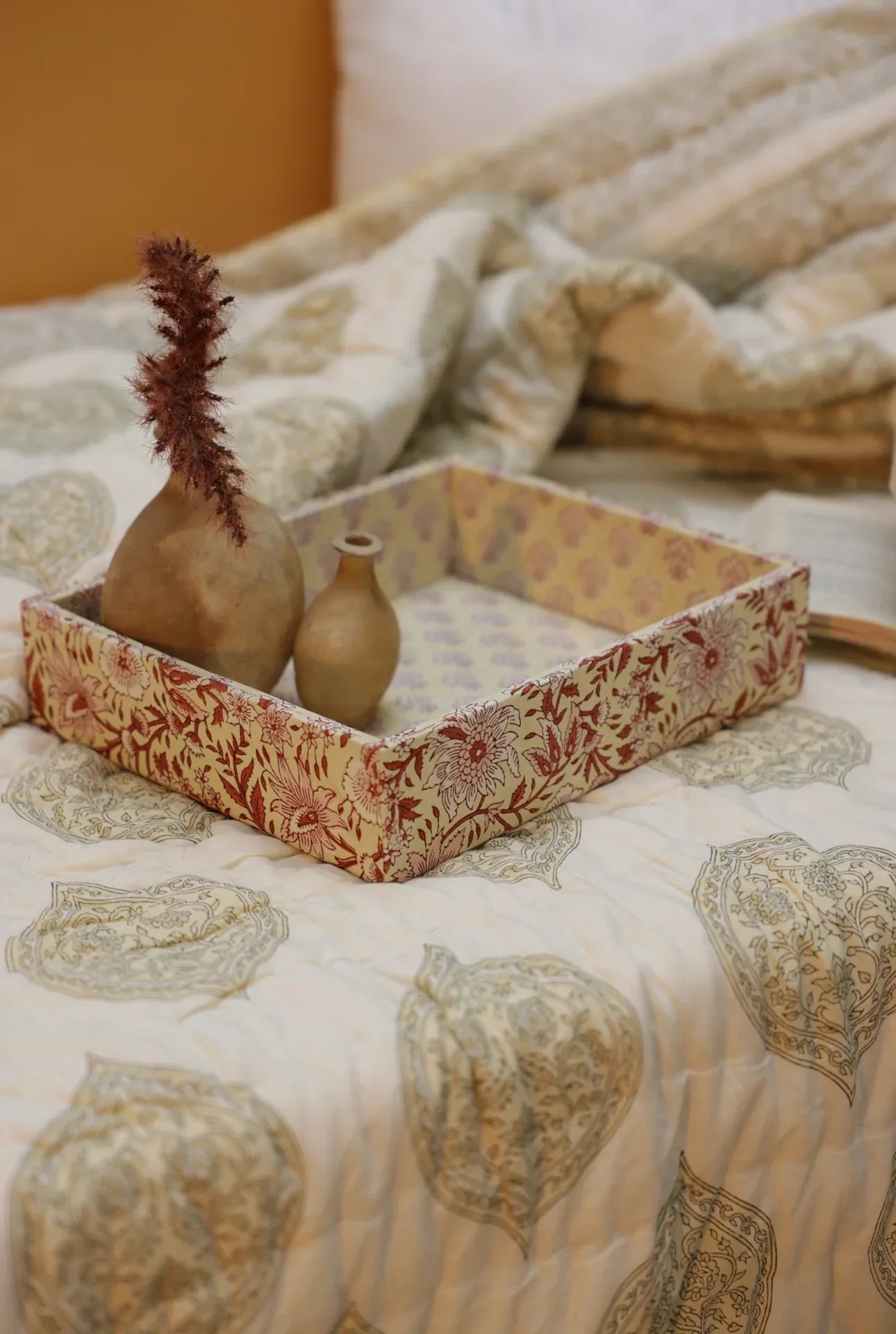 A fabric decorative tray laid on kiftsgate stone quilt