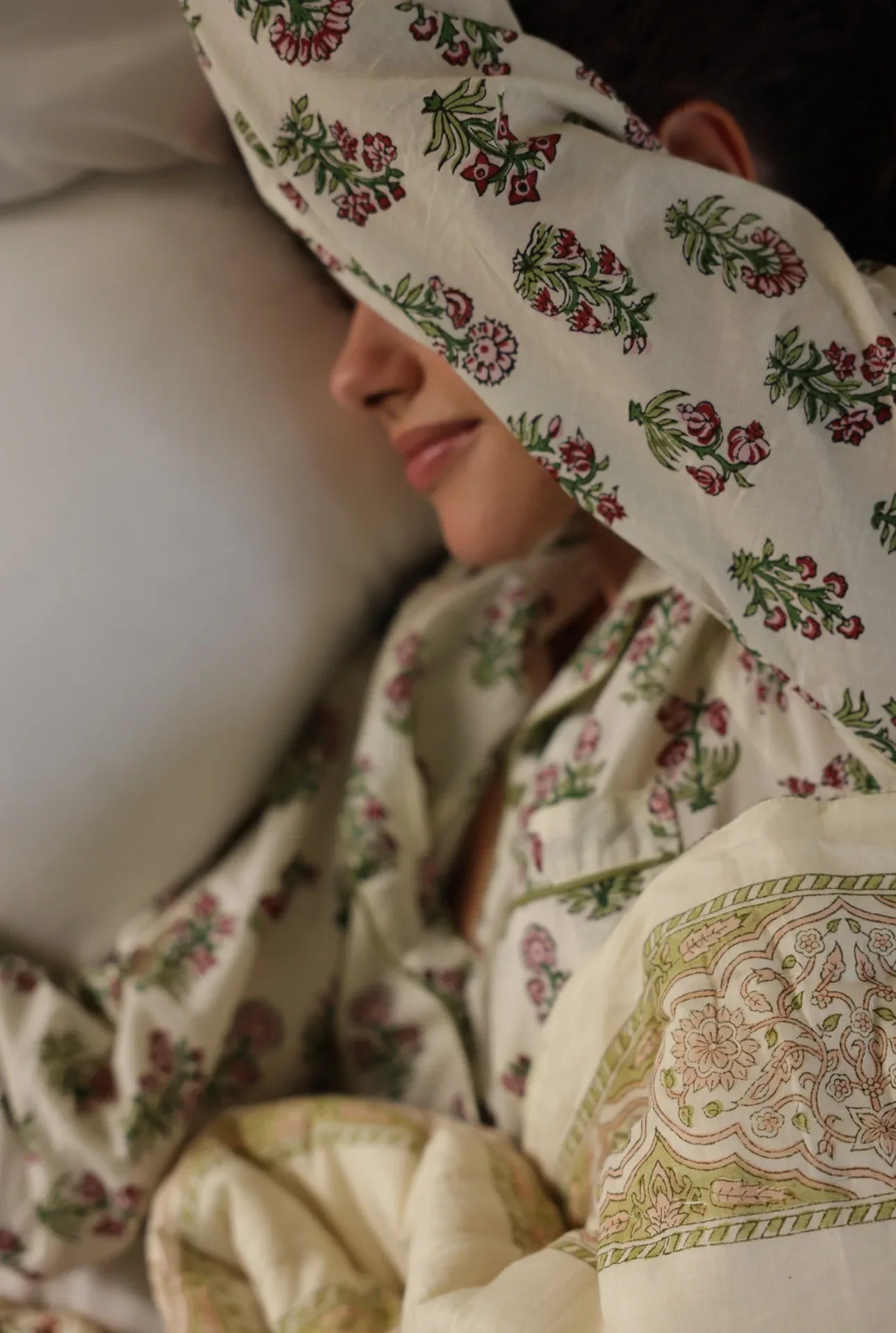 Model lying in bed in cotton pyjamas