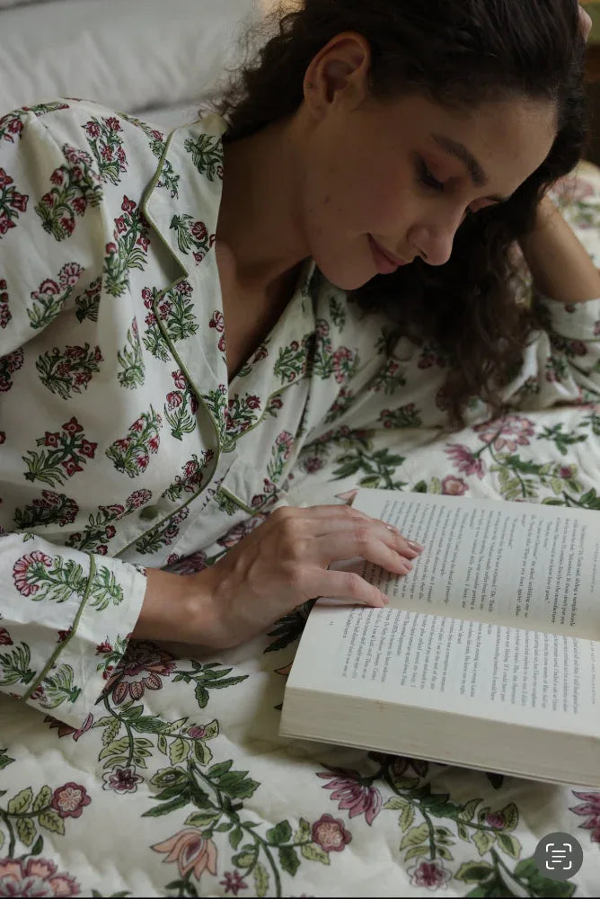 Model laid down on paxford willow quilt reading a book