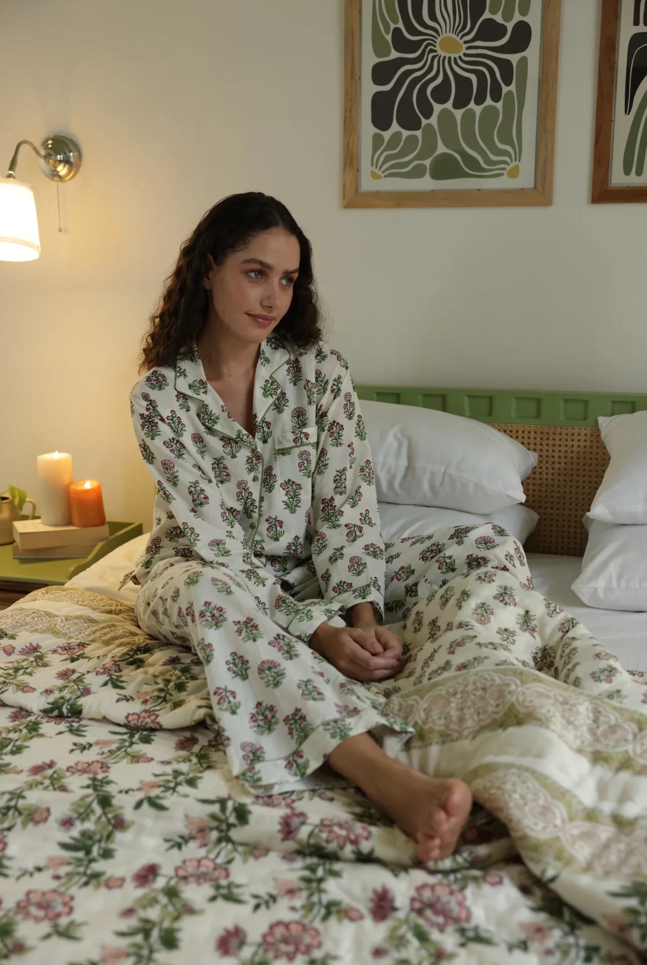 Model sat up in floral whisper pyjamas on paxford willow quilt