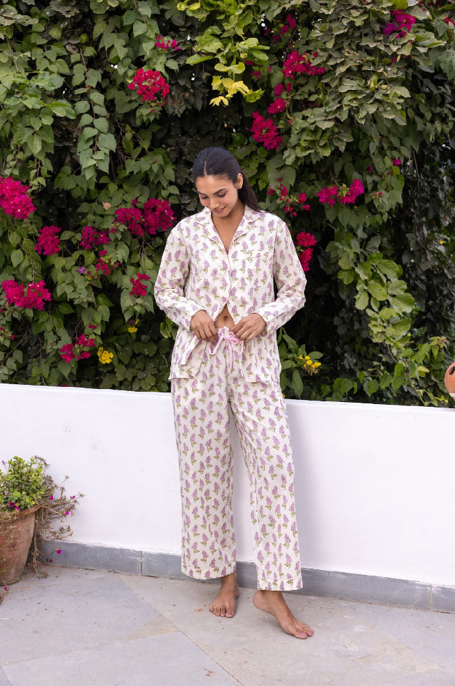 Model wearing pink and cream cotton pyjamas