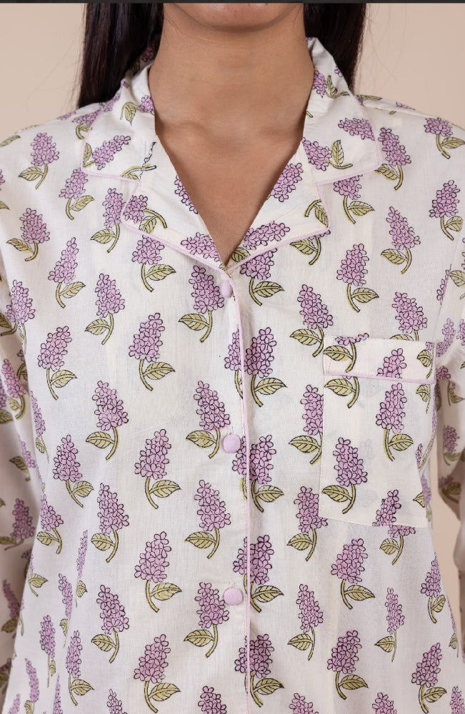 Model_wearing_pink_and_cream_cotton_pyjamas_in_a_shopify_image