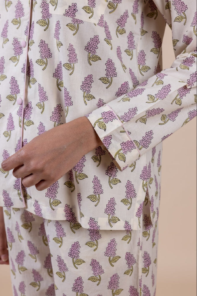 Model_wearing_pink_and_cream_cotton_pyjamas_in_a_shopify_image