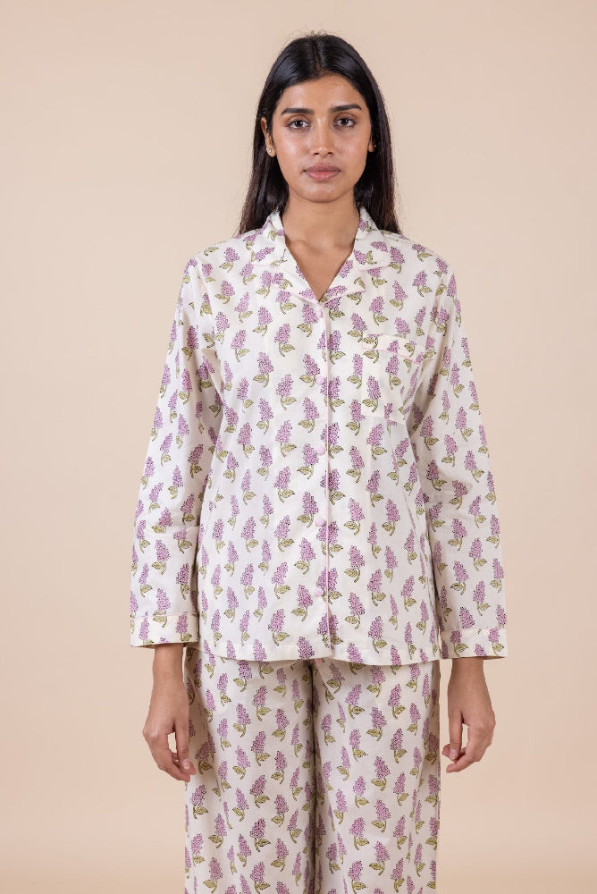 Model_wearing_pink_and_cream_cotton_pyjamas_in_a_shopify_image