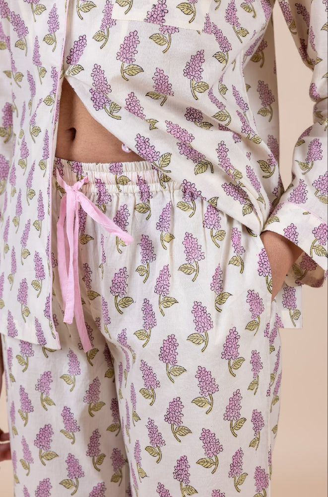 Model_wearing_pink_and_cream_cotton_pyjamas_in_a_shopify_image