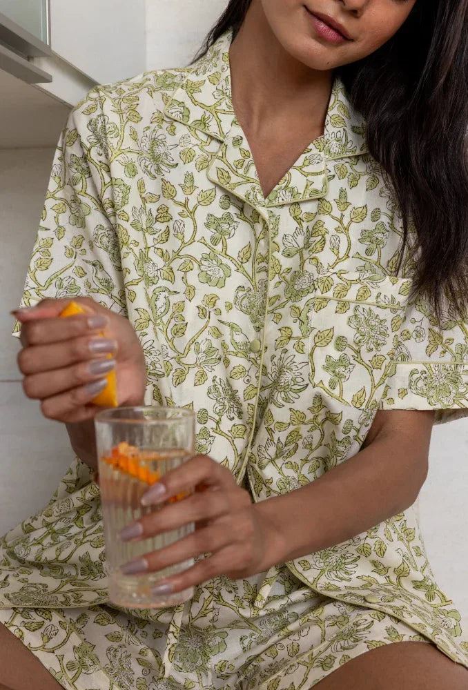 Model with a glass of water wearing Westington Sage Cotton Pyjamas