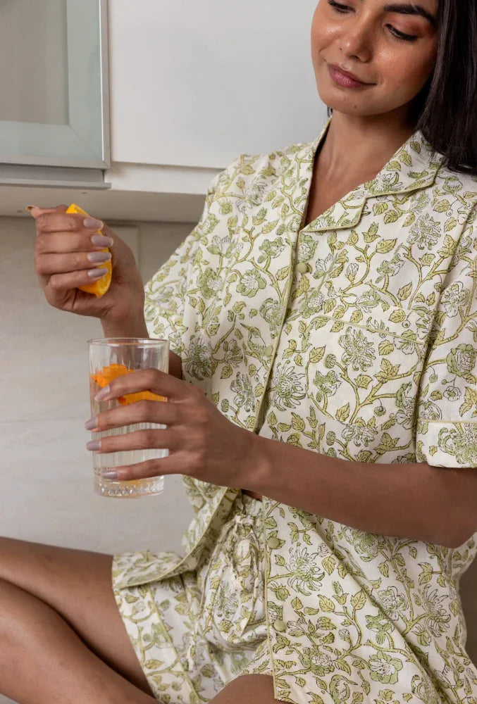 Model sat wearing Westington Sage Cotton Pyjamas