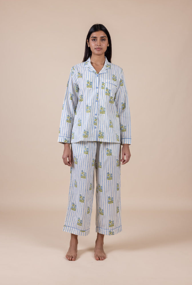 Woman wearing a matching pajama set with a beige background