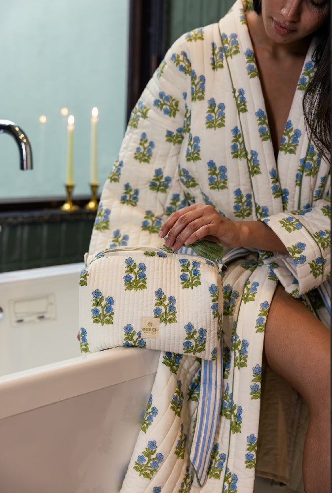 Blue and green floral quilted wash bag in lifestyle image