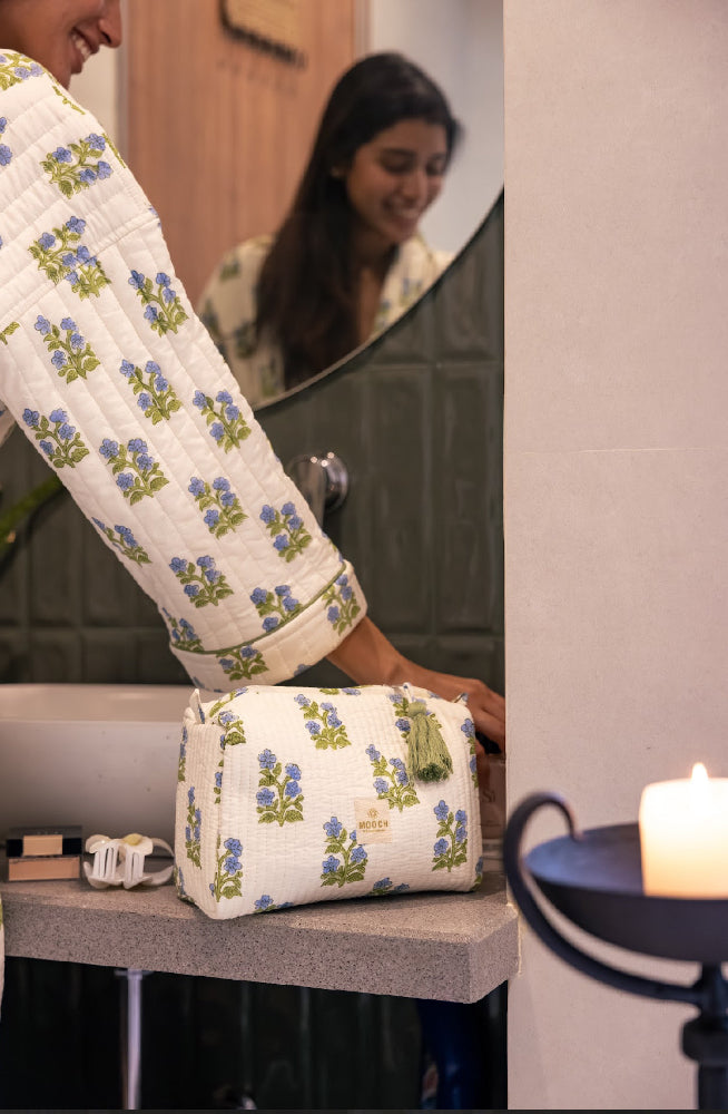 Blue and green floral quilted wash bag in lifestyle image