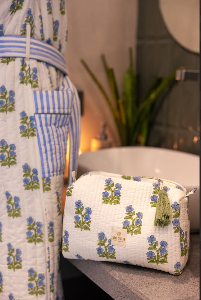 Blue and green floral quilted wash bag in lifestyle image