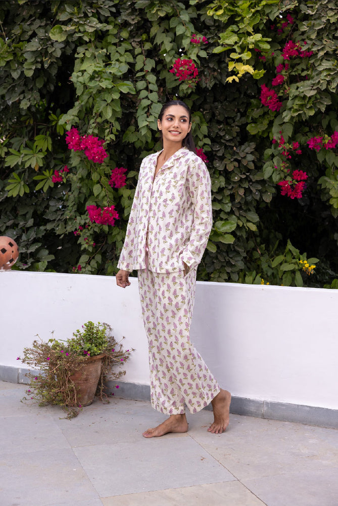 Model_wearing_pink_and_cream_cotton_pyjamas_in_a_lifestyle_image