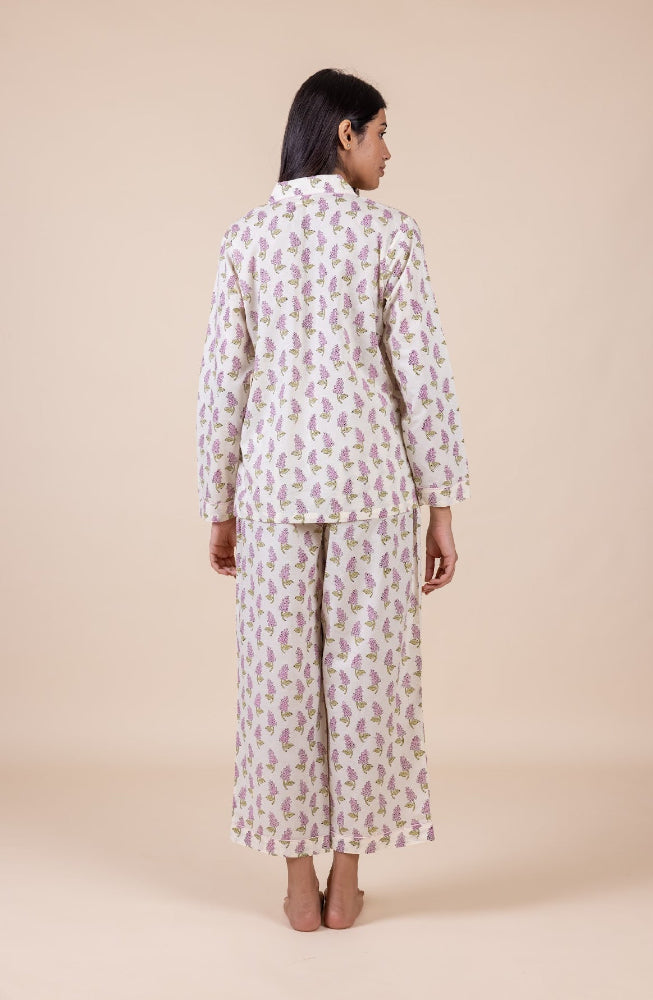 Model_wearing_pink_and_cream_cotton_pyjamas_in_a_shopify_image